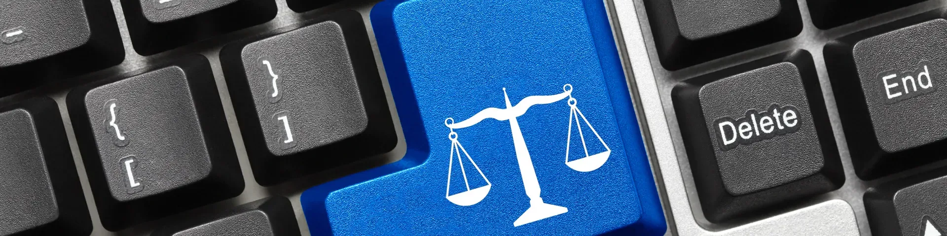 Keyboard with a blue key showing the scales of justice