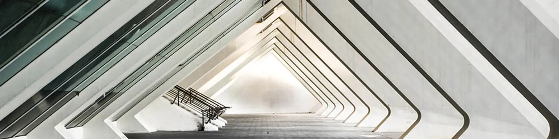 Looking down a white arched architectural corridor