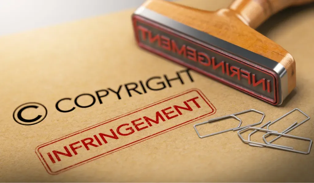 A rubber stamp beside the words “Copyright infringement” stamped on a manila folder